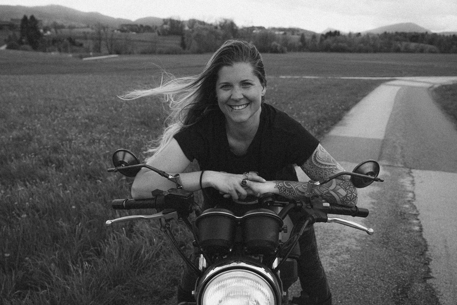 Woman with Tattoos on a motorcycle